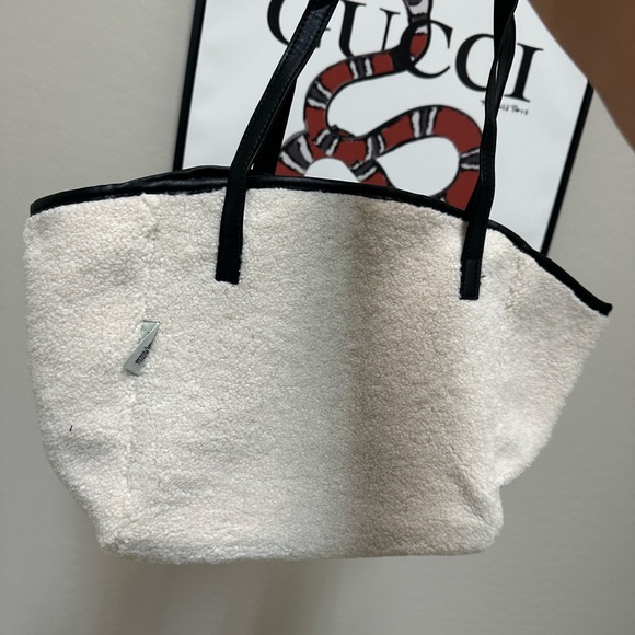 Tote Bag in cream ;Neiman Marcus
Faux Shearling Tote with makeup bag - Picture 4 of 9